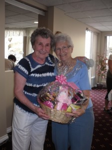 Maxine, our Resident of the Year, presents the lovely Gift Basket to our Hospice Fundraiser Winner