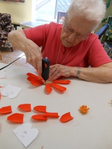 Mary glue gunning all her petals into place.